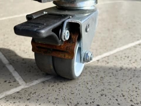 Rust visible around the brake spring on outdoor furniture castors