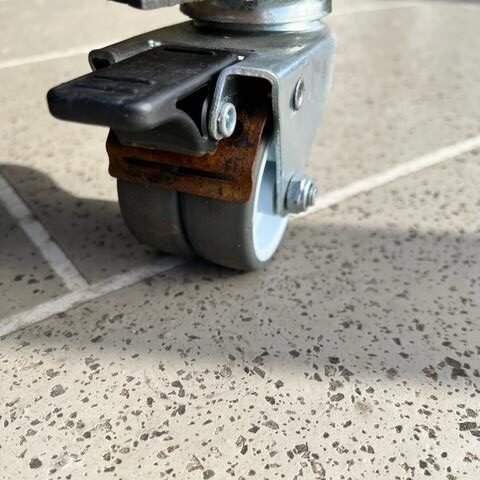 Rust visible around the brake spring on outdoor furniture castors