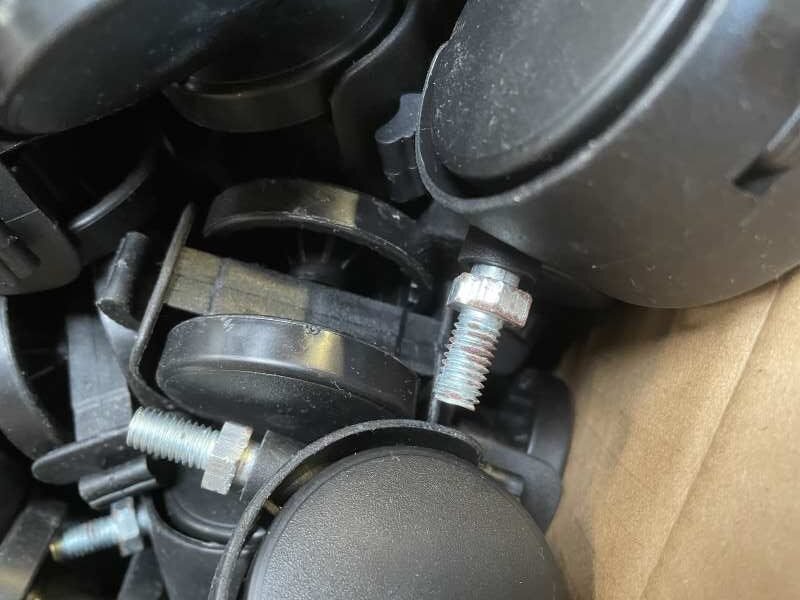 Small black nylon castor with visible threaded-stem corrosion