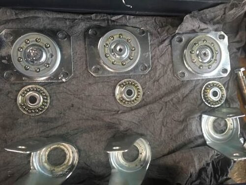 Opened industrial castor swivel assemblies showing different ball configurations